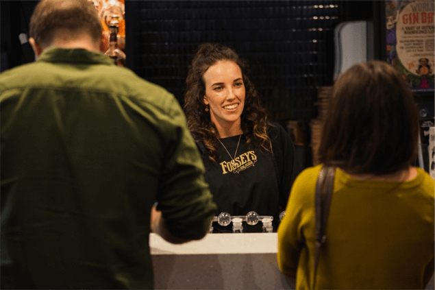 smiling woman at a bar