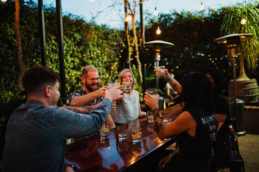 friends cheers in gin garden at fossey's